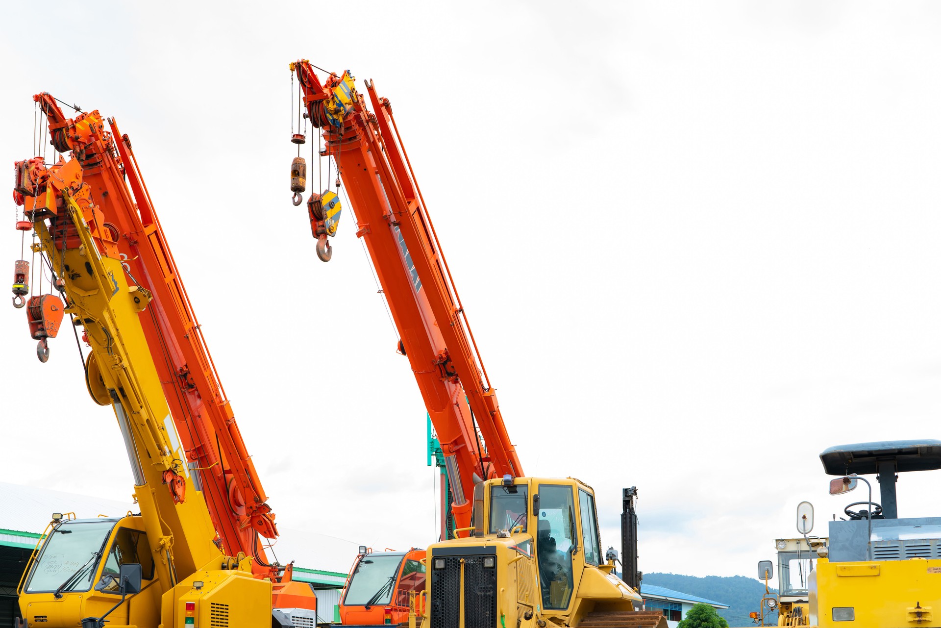 Industrial machinery. Construction crane for heavy lifting in the industry. Yellow construction crane with hook. Equipment for rent and sale. Crane dealership for construction business. Heavy lifting.
